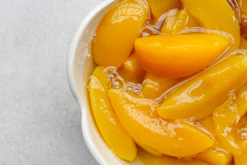 Sliced peaches in syrup served in a bowl