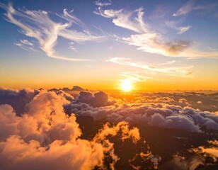 Aerial view of a radiant sunrise above soft white clouds, streaked by wispy formations
