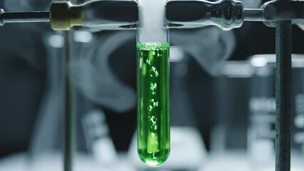 Bubbling green liquid in a test tube during a chemical experiment