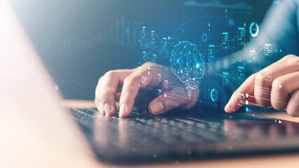 Hands typing on a laptop with digital AI graphics, neural network structures, and data flow elements, representing artificial intelligence, machine learning, and advanced technology processing.