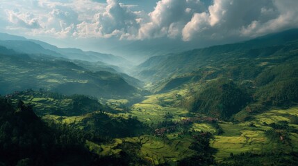 A mountain range with a valley in between. The valley is lush and green, with a few houses scattered around. The sky is cloudy, giving the scene a peaceful and serene atmosphere