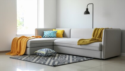 Contemporary interior design featuring a curved sofa, vibrant throw blankets, and geometric pillows, accented by a minimalist hanging lamp