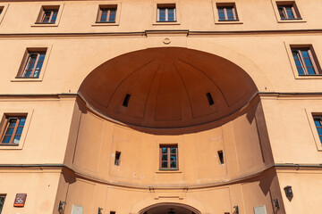 Historic european building facade with symmetrical windows and arched entrance. Warsaw, Poland.