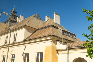 Historic building with tan roof against clear blue sky. Żyrard&oacute;w railway station. Żyrard&oacute;w, Poland.