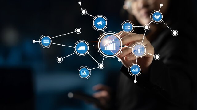 A business professional interacts with a virtual touchscreen to explore data connections and insights, showcasing the impact of technology in decision-making processes. Tessel