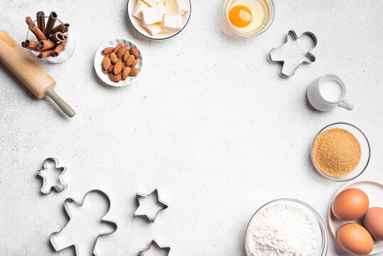 Christmas baking background with baking ingredients and cookie cutters