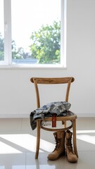 A pair of tan military boots sits neatly on the floor beside a rustic wooden chair