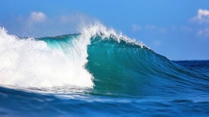Fototapeta premium Majestic Pacific Ocean wave crashing against the shoreline at midday