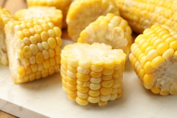 Pieces of boiled corn cobs on table, closeup