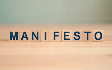 Manifesto Word Spelled on Wooden Blocks on Table Concept