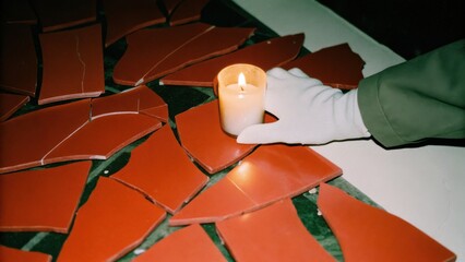 Dark Chirstmas Broken ceramics with a candle in a dark atmosphere.
