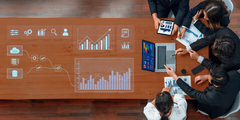 A business team collaborates in a modern office, leveraging digital tools and analytics to drive informed decisions using charts, graphs, and data insights. Trope