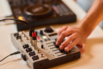 Closeup of tactile controls and vibrant patch cords in studio, Adjusting analog sequencing equipment with bright cables and warm ambient lighting in home studio