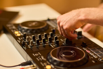 Obraz premium DJ setup overview, Energetic club DJ performing with digital controller in action, Content creator mixing music live using digital turntables under vibrant stage lights