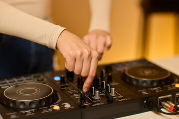 DJ setup overview, Energetic club DJ performing with digital controller in action, Content creator mixing music live using digital turntables under vibrant stage lights