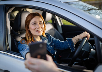 Woman in car pays at drive-thru window