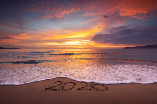 tropical beach and sunrise over the sea shore with splashed waves in the sand, ocean sunset landscape 2026 text ont he sea sand