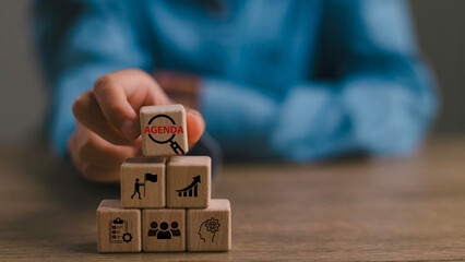 Agenda meeting appointment activity information concept. List of meeting activities in the order to be taken up, beginning with the call to order, ending with adjournment. Wooden cubes background