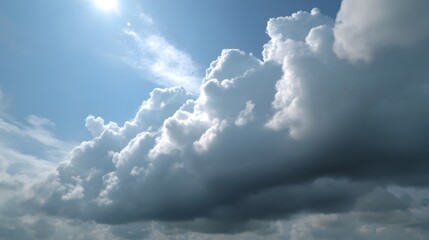 Dramatic cumulus clouds drift across a bright blue sky illuminated by the midday sun