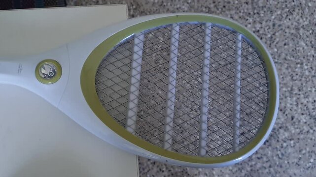 A close up view of mosquito bat or bug zapper racket or electric fly swatter