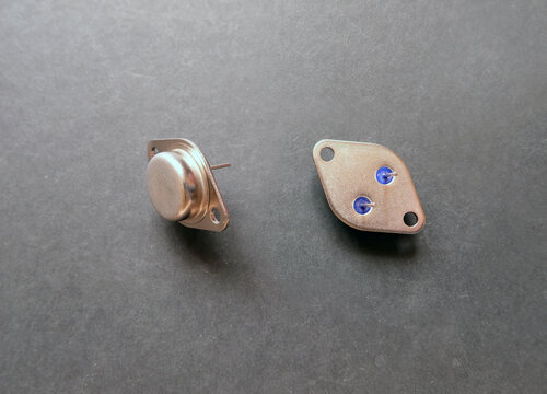 Metal cased power transistors on a black.