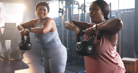 Diverse female friends starting workout grabbing kettlebells on gym mat doing upright rows for tone - Powered by Adobe