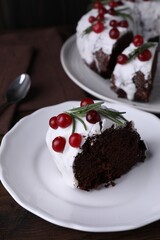 Tasty Christmas cake with cranberries and rosemary on table, closeup