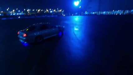 Drift car shows a master class on wet asphalt at night. Shooting from a drone. Russia. Moscow. 05.12.25