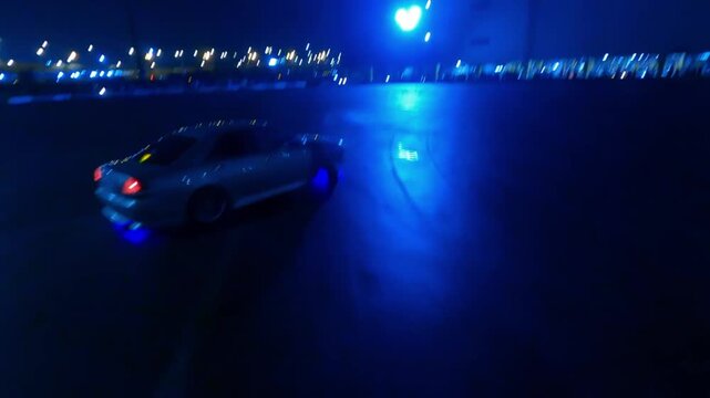 Drift car shows a master class on wet asphalt at night. Shooting from a drone. Russia. Moscow. 05.12.25