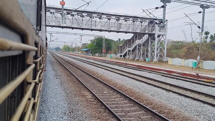 Video of quiet tracks and vacant platforms pass gently, creating a soothing rhythm of journey