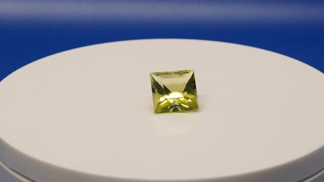Square Oro Verde Gemstone Rotating on Blue Background &ndash; Faceted Green Quartz Video