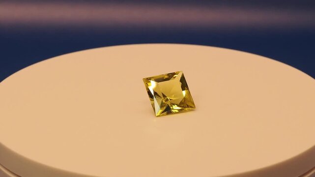 Square Oro Verde Gemstone Rotating on Blue Background &ndash; Faceted Green Quartz Video