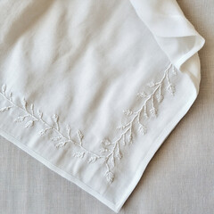 Clean white linen fabric with embroidery. Minimalist background napkin for product mockups.