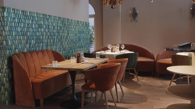 Mosaic tiled corner with cozy seating, Intimate bistro area with curved benches and wooden tables