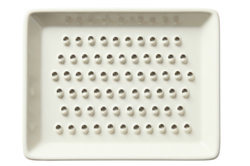 White ceramic ginger and garlic grater plate with sharp teeth on a transparent background