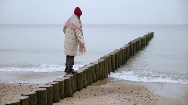 Contemplative Baltic Sea portrait on wooden breakwater at Misty Shoreline