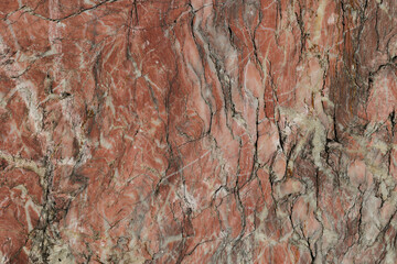 dettagli macro di una superficie naturale di un minerale lavorato dalle sfumature di rosso