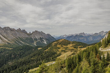 Fototapeta premium vista panoramica su di un vasto ambiente naturale tra le montagne della regione Friuli Venezia Giulia, nel nord Italia, di pomeriggio, con cielo coperto, in autunno