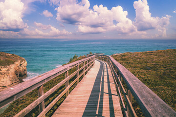 Wooden walkway on the rocky seashore. Photon viewpoint (Miradoiro de Foton) near Cathedrals Beach