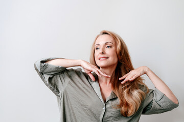 Morning self care routine of a woman in pajamas in the bathroom mirror