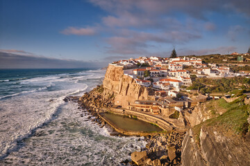 Scenic view of the seaside Azenhas do Mar fishing village on cliff on Atlantic ocean coast, Portugal on sunset