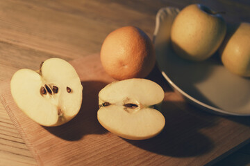 Apple cut in half, fruit on kitchen table, interior
