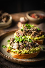 Toast avocado, mushrooms and microgreens whole grain sandwich. Vegetarian food. Vegan menu. Delicious breakfast or snack, Clean eating, dieting, vegan food concept.