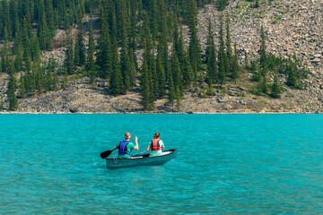 Couple kayaking on Moraine Lake, Banff national park, Alberta, Canada.