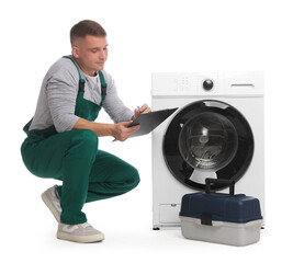 Repairman in uniform with pen, clipboard, toolbox and washing machine on white background