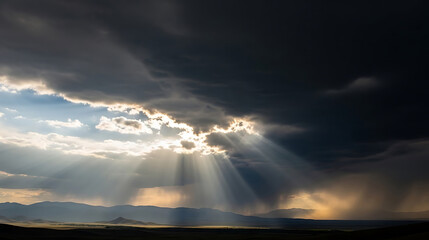 Dramatic sunbeams pierce through stormy clouds