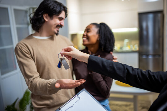Couple receiving apartment keys from agent