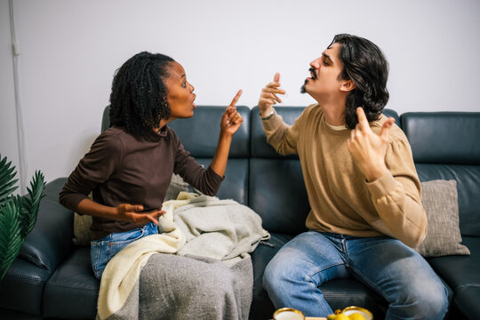 Couple arguing on sofa - Powered by Adobe
