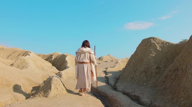 A detailed close-up of a traveler's feet in ancient rope sandals, standing beside a prominent rock on parched, cracked earth. Christian and spiritual concept