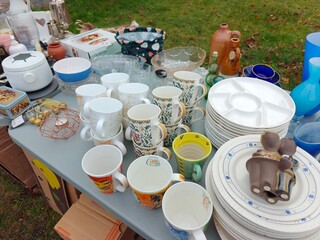 Vintage and everyday household items displayed in a thrift store, second-hand shop interior with retro objects and used goods for resale
